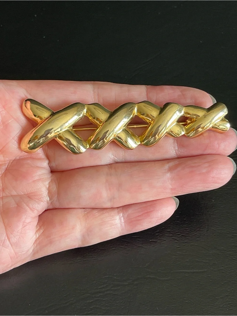 Vintage gold tone xxxx brooch.